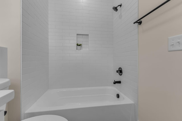 bathroom featuring shower / tub combination and toilet