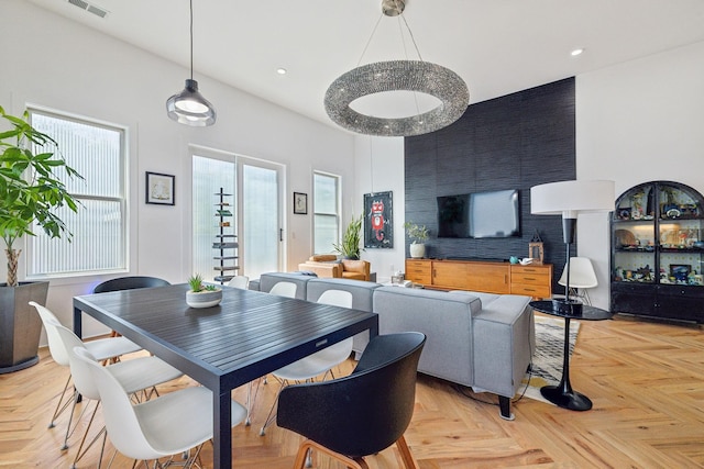 dining area with light parquet flooring and plenty of natural light