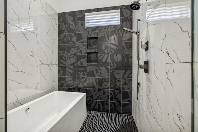 bathroom featuring tile walls and shower with separate bathtub