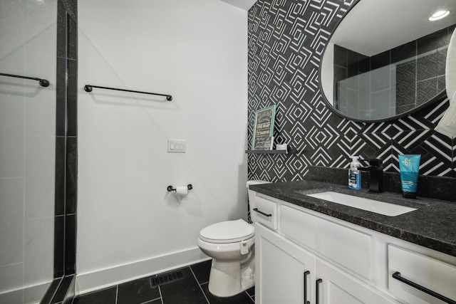 bathroom with tile patterned flooring, toilet, vanity, and decorative backsplash