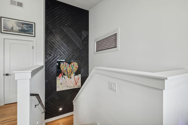 stairs with hardwood / wood-style flooring