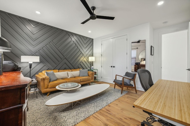 living room with ceiling fan and light wood-type flooring