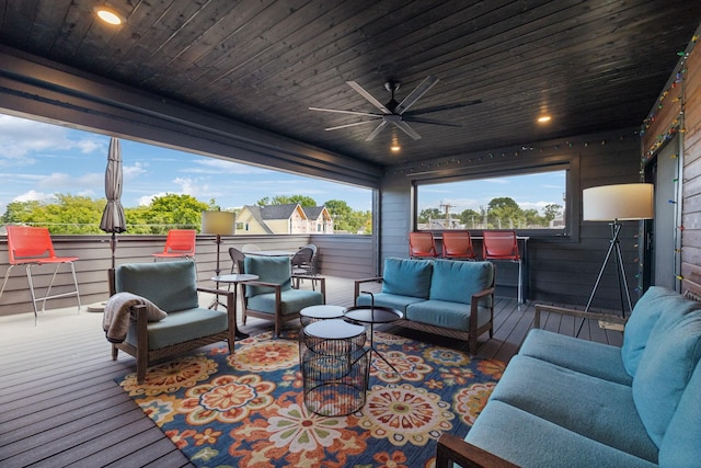 wooden terrace with an outdoor hangout area and ceiling fan