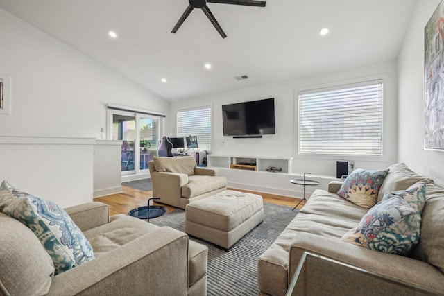 living room with lofted ceiling, hardwood / wood-style flooring, and ceiling fan