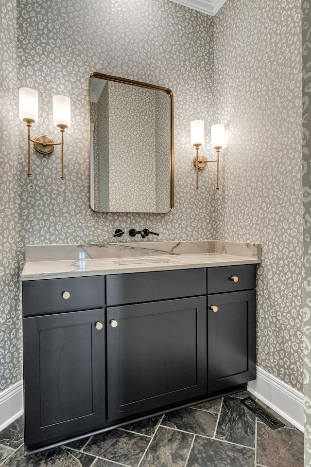 bathroom featuring ornamental molding and vanity