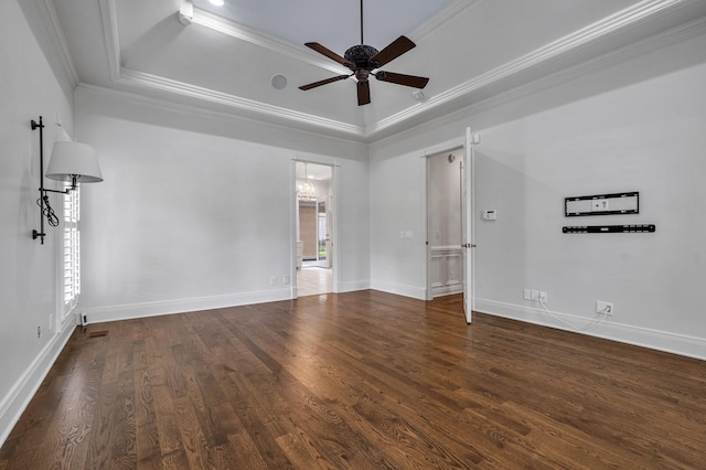 unfurnished room featuring a tray ceiling, ornamental molding, dark hardwood / wood-style floors, and ceiling fan