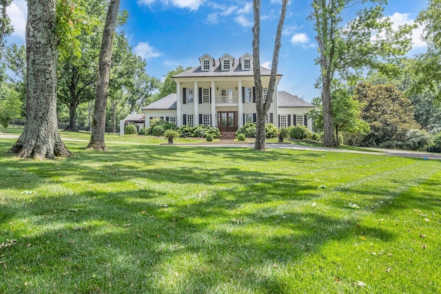 view of front facade featuring french doors and a front lawn