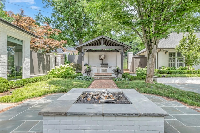 exterior space featuring a gazebo, a patio, and an outdoor fire pit