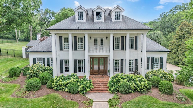 view of front of property featuring a front yard and french doors