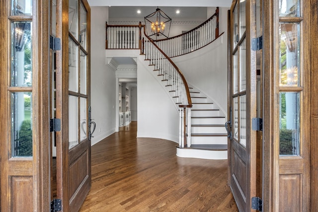 entryway with french doors, dark hardwood / wood-style floors, and a wealth of natural light