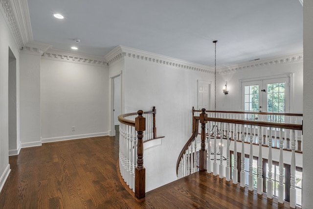 corridor with crown molding, dark wood-type flooring, and french doors