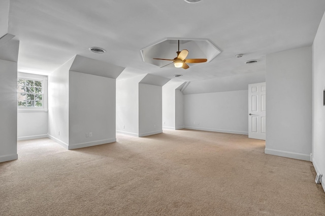 bonus room with lofted ceiling, light colored carpet, and ceiling fan