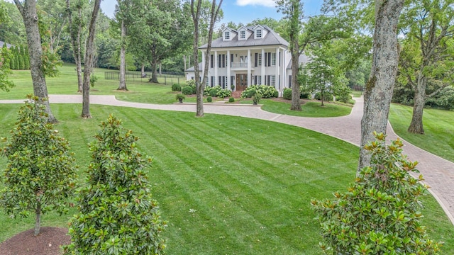 exterior space with a porch and a front yard