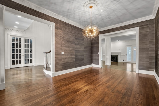 interior space with an inviting chandelier, dark hardwood / wood-style flooring, and french doors