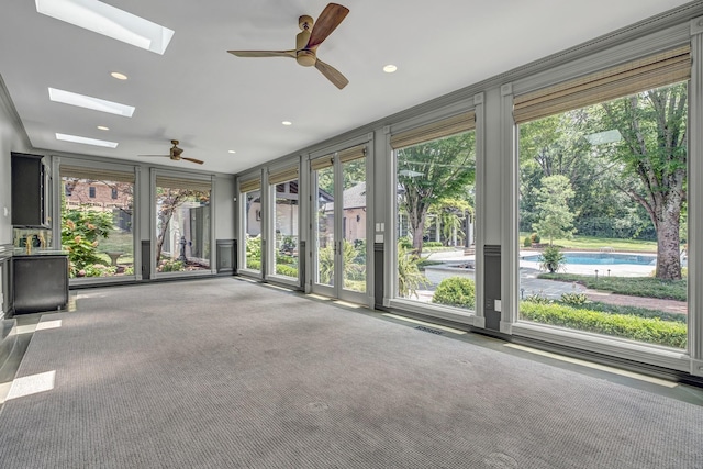 unfurnished sunroom featuring a wealth of natural light and a skylight