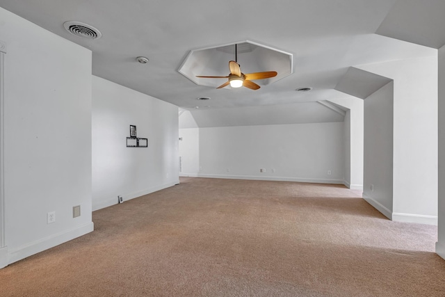 bonus room with ceiling fan, vaulted ceiling, and light carpet