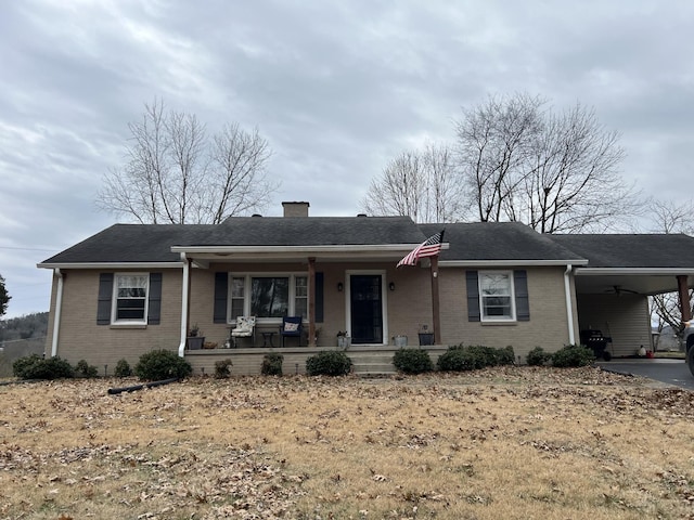 ranch-style house with a porch and a carport