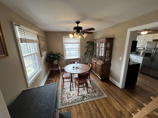 dining area featuring dark hardwood / wood-style floors and ceiling fan