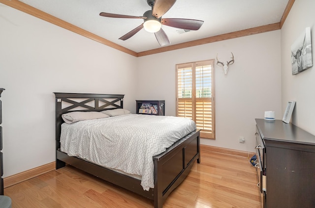 bedroom with ornamental molding, ceiling fan, and light hardwood / wood-style floors