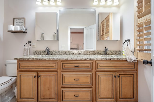 bathroom with vanity and toilet