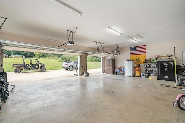 garage with white refrigerator and a garage door opener