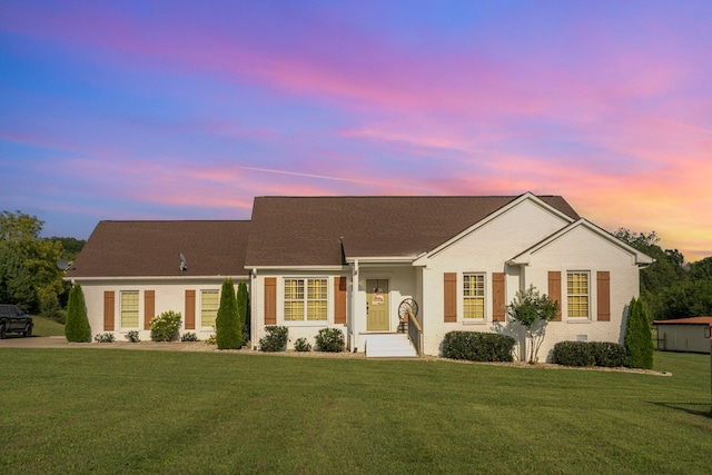 ranch-style home featuring a lawn