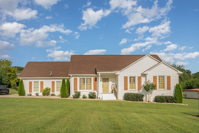 ranch-style home featuring a front yard