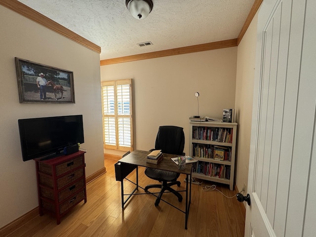 office area featuring crown molding, light hardwood / wood-style floors, and a textured ceiling