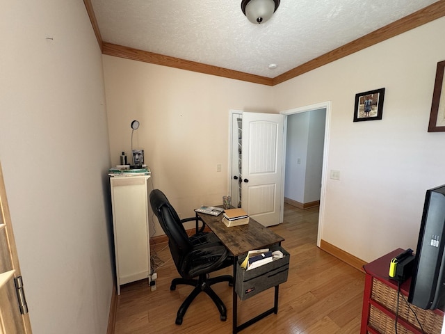 office featuring ornamental molding, a textured ceiling, and light wood-type flooring