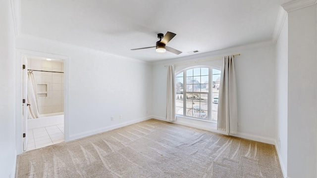 carpeted spare room featuring crown molding and ceiling fan