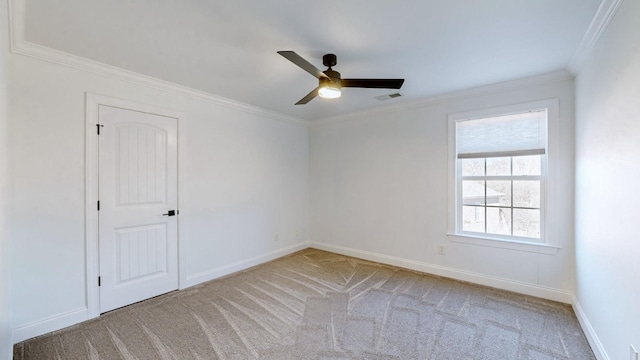 carpeted empty room with crown molding and ceiling fan