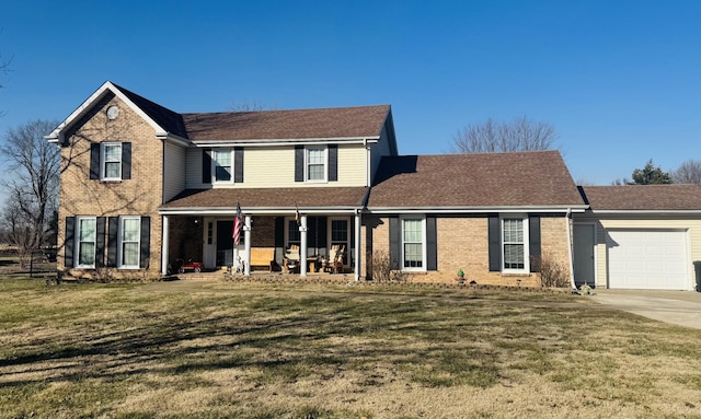 view of front of home with a garage, a front yard, and covered porch