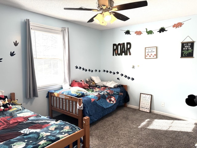 carpeted bedroom with ceiling fan and a textured ceiling