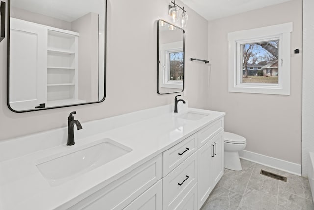 bathroom featuring plenty of natural light, toilet, tile patterned flooring, and vanity