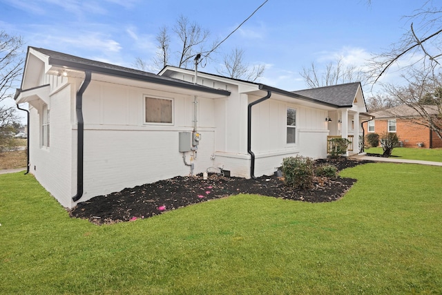 view of side of home featuring a lawn