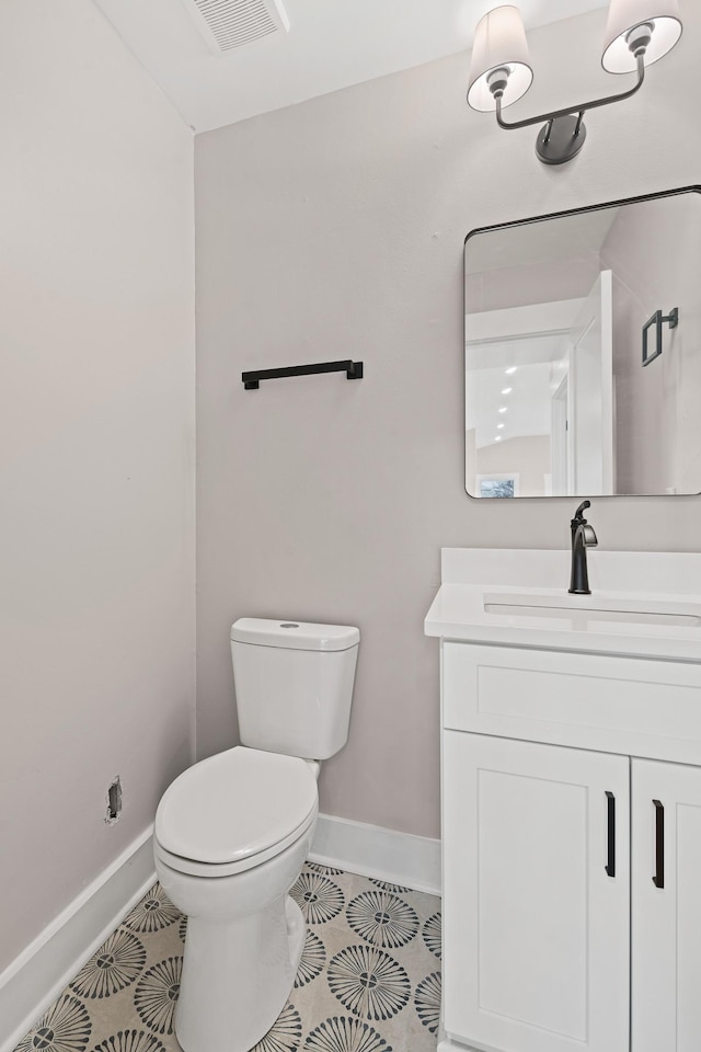 bathroom with vanity, tile patterned floors, and toilet