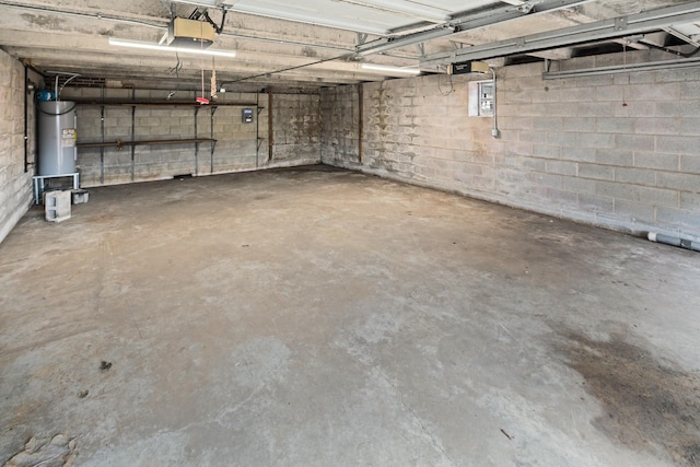 garage featuring a garage door opener and water heater