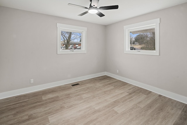 unfurnished room with ceiling fan and light wood-type flooring