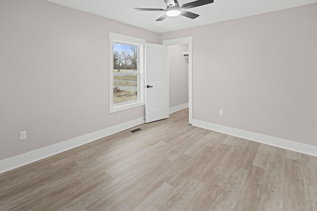 empty room featuring ceiling fan and light wood-type flooring