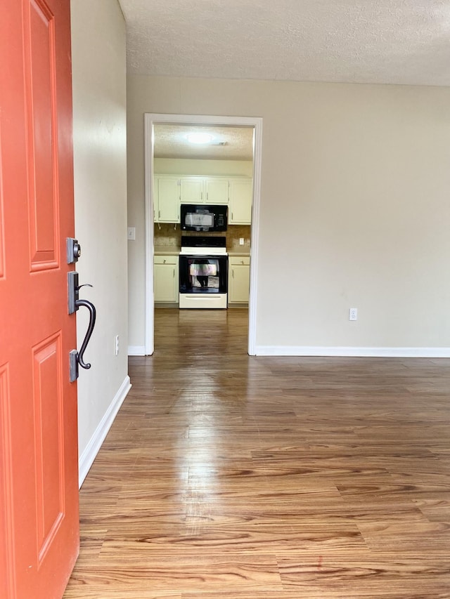 foyer featuring light hardwood / wood-style flooring and a textured ceiling