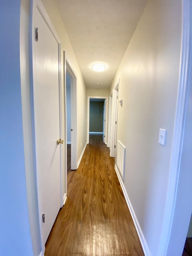 hallway featuring wood-type flooring