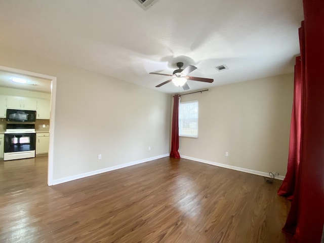 spare room featuring dark hardwood / wood-style floors and ceiling fan