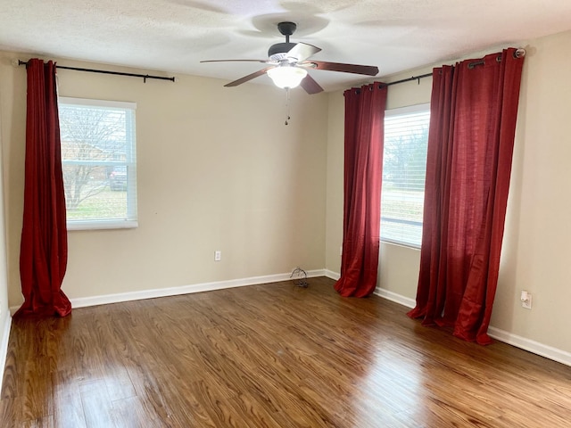 spare room with wood-type flooring, a textured ceiling, and ceiling fan