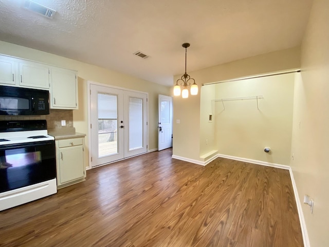 kitchen featuring electric stove, decorative light fixtures, white cabinetry, light hardwood / wood-style flooring, and french doors