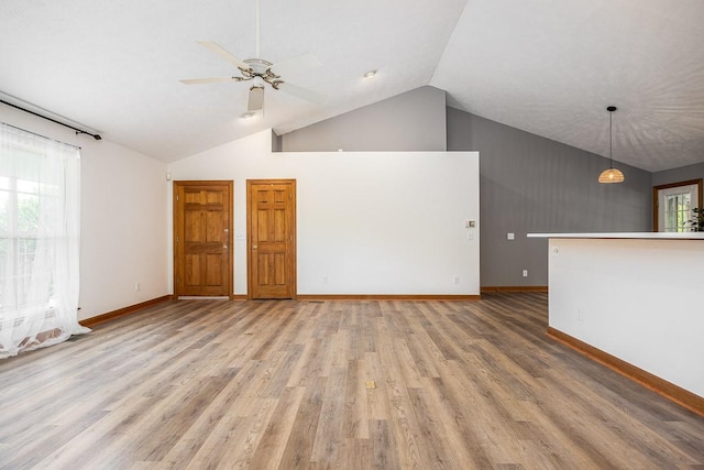 unfurnished living room featuring vaulted ceiling, ceiling fan, and hardwood / wood-style floors