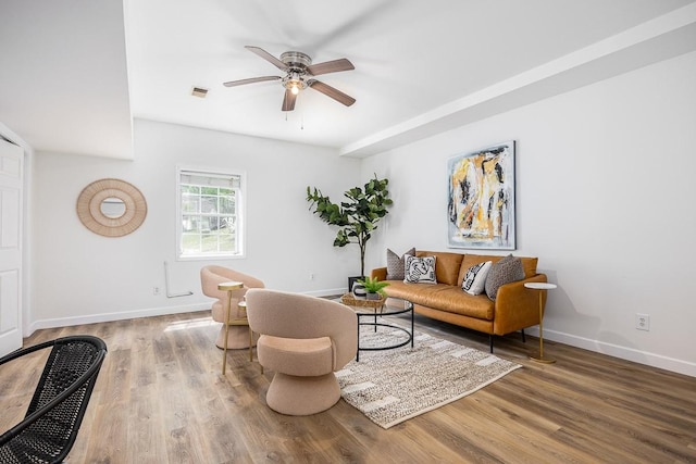 living room with wood-type flooring and ceiling fan