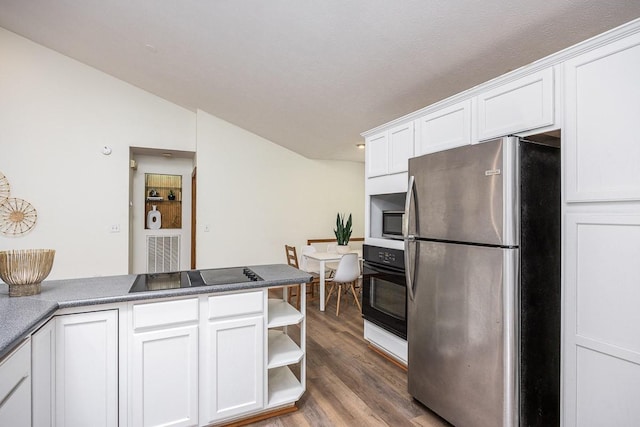 kitchen featuring dark hardwood / wood-style floors, black appliances, white cabinetry, lofted ceiling, and kitchen peninsula