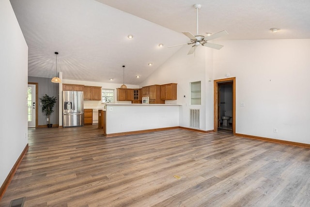 unfurnished living room with ceiling fan, high vaulted ceiling, and hardwood / wood-style floors