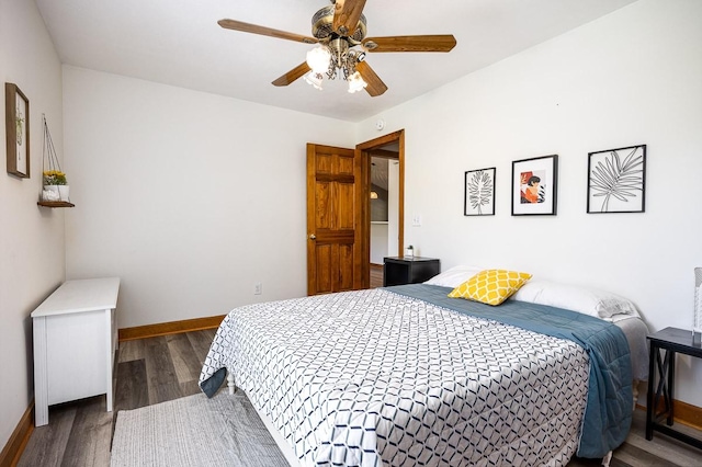 bedroom with dark hardwood / wood-style floors and ceiling fan