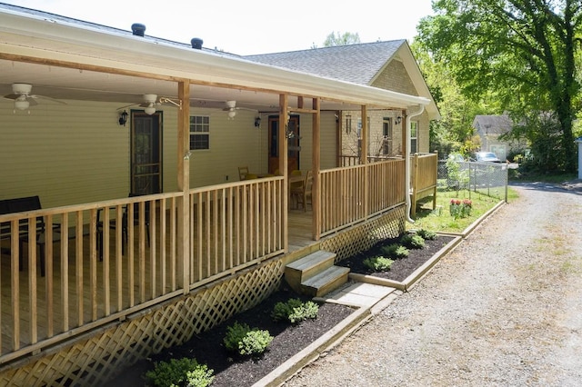 view of side of home featuring a porch and ceiling fan